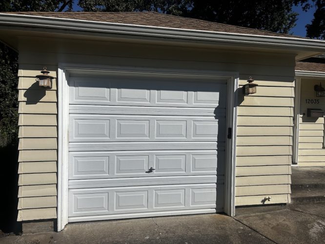 White garage door on yellow Gies house, 12035, with lanterns. Painted by Pearl Painters in Portland. July 2025.
