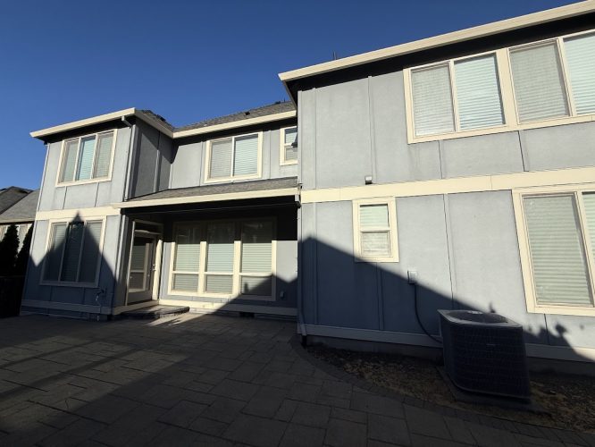 Pearl Painters painted this two-story gray house with white trim and large windows in Portland, July 2025.
