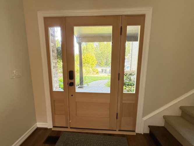 Wood front door with glass panels at Buck residence, green yard, stone path. Painted by Pearl Painters, Portland, July 2025.