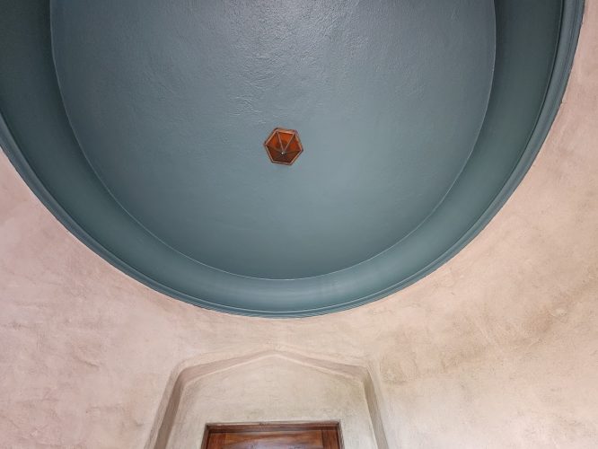Teal-painted ceiling by painter Ralph Barron, Portland. Pearl Painters finishing exterior by August 2025. Hex light, arched door.