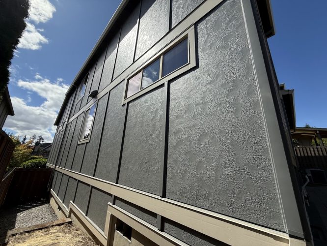 Pearl Painters painting a tall, gray stucco house with rectangular windows in Portland, July 2025.