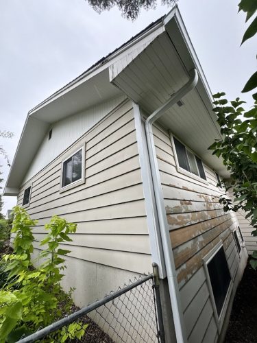 Cleveland house with peeling paint, weathered siding; likely prepped for painting. Not Portland or Pearl Painters.