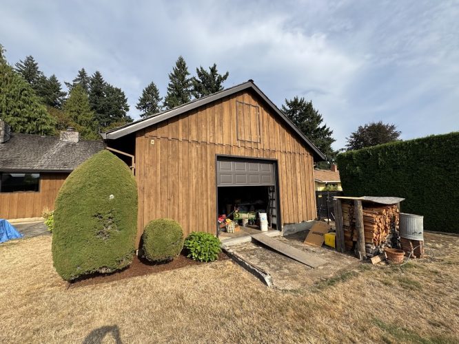 Craytor wooden garage in Portland; tools, storage, firewood, and trimmed bushes visible. Pearl Painters project for August 2025.