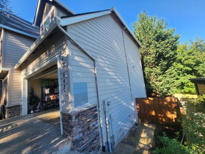 Pearl Painters painting a light gray Holley house in Portland, address 8427, with blue and gray swatches. July 2025.