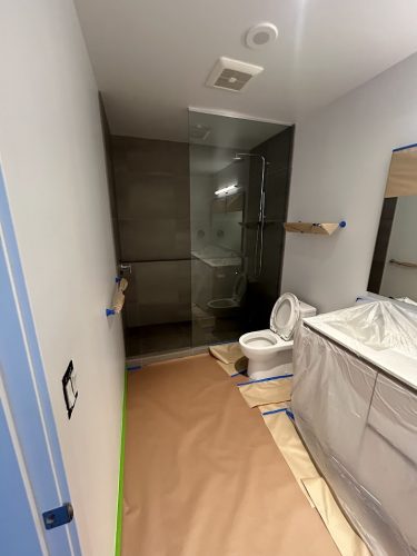 Allen bathroom under renovation with floors and fixtures covered for painting by Pearl Painters; completion July 2025.