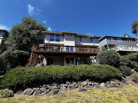 A two-story Featherstone house with balcony in Portland, painted by Pearl Painters, August 2025.