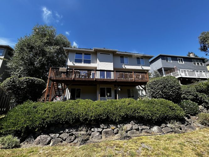 A two-story Featherstone house with balcony in Portland, painted by Pearl Painters, August 2025.