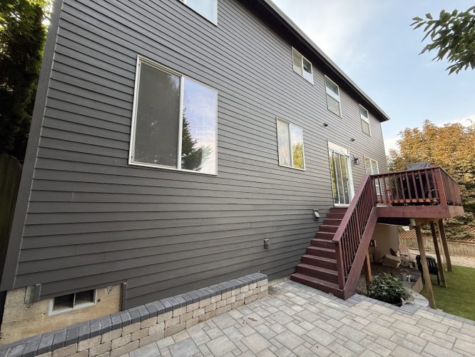 Pearl Painters painted a dark gray two-story Montoya house in Portland with deck, patio, and windows, completed August 2025.