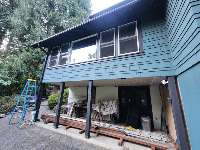 Portland two-story house with teal siding; Pearl Painters' tools and ladder suggest exterior painting in progress for Aug 2025.