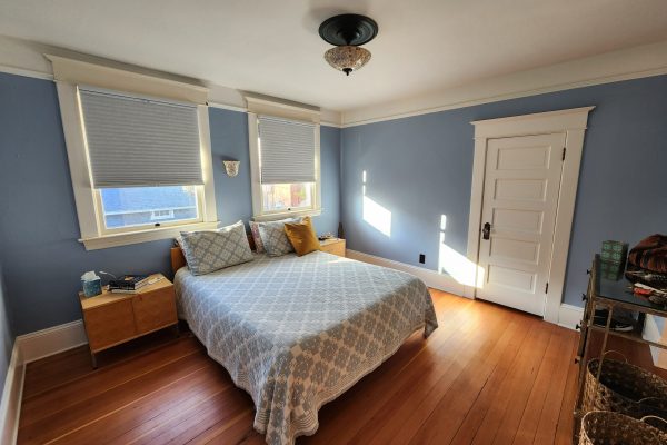 bedroom painted light blue with white trim