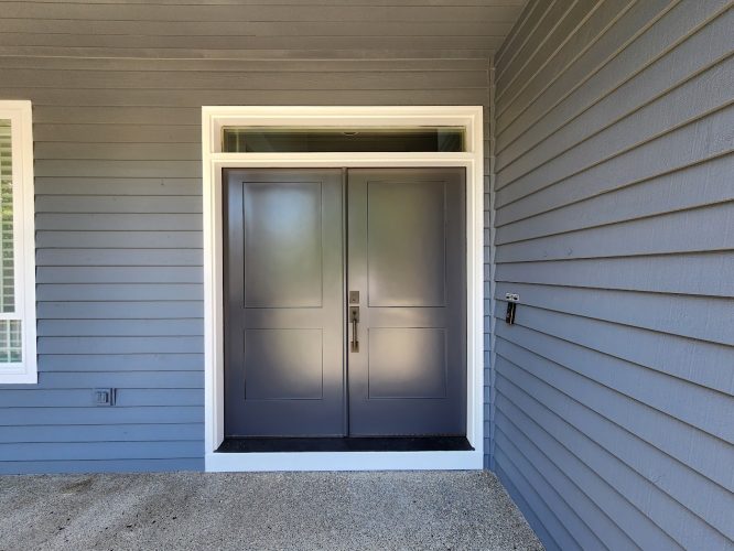 Modern Roberts double front door, dark gray panels, white frame, blue-gray siding; painted by Pearl Painters in Portland.