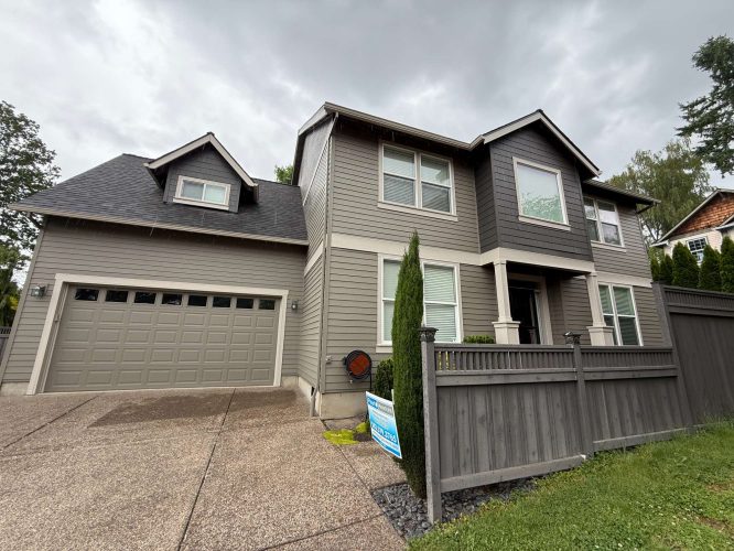 Two-story modern house with gray siding, two-car garage, and fenced front yard in Austin (not Portland). Available May 2025. No painting or painter details; not affiliated with Pearl Painters.