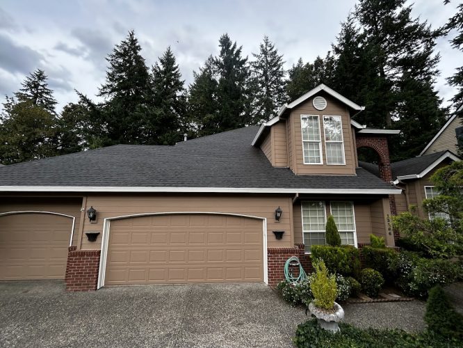 Charming two-story Haase house in Portland with brown exterior, brick accents, two-car garage, and front garden. Pearl Painters will complete painting by June 2025.