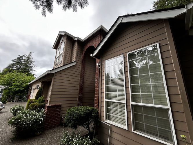 Haase exterior: Two-story brown house with white-trimmed windows, red brick accents, and landscaping. Painted by Pearl Painters, Portland.
