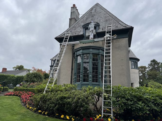 Painter Ralph Barron paints a two-story house in August 2025; scaffolding, ladders, garden below. Pearl Painters, Portland.