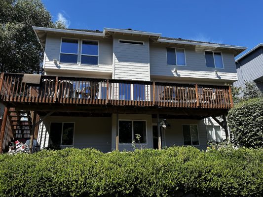 Two-story Featherstone home in Portland with light siding, balcony, large windows; Pearl Painters prepped for painting by Aug 2025.