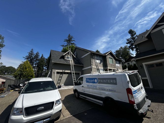Two vehicles, including a "Pearl Painters" van, are parked in front of a house in Austin with ladders set up for exterior painting. The weather is clear and sunny in May 2025.