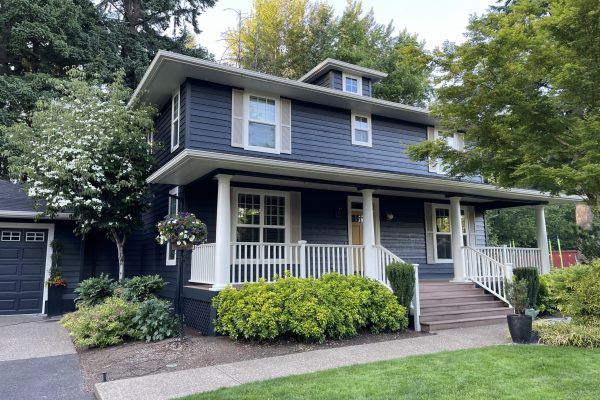 A blue house with white trim in the West Linn Neighborhood, boasting a fresh exterior paint job after 20 years.