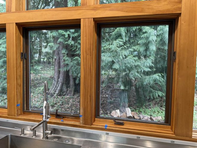 Oak window trim with multiple dents and damage before repair by Pearl Painters in Portland.