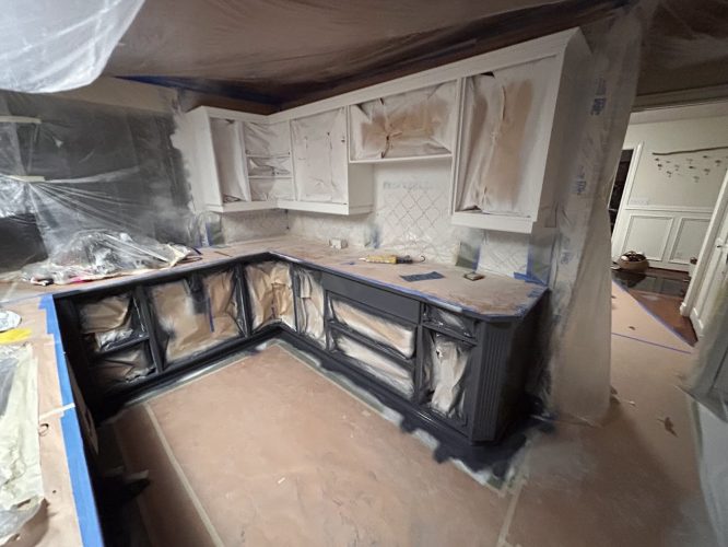 Portland kitchen being painted by Pearl Painters; cabinets taped and covered, plastic sheets protect floor and areas.