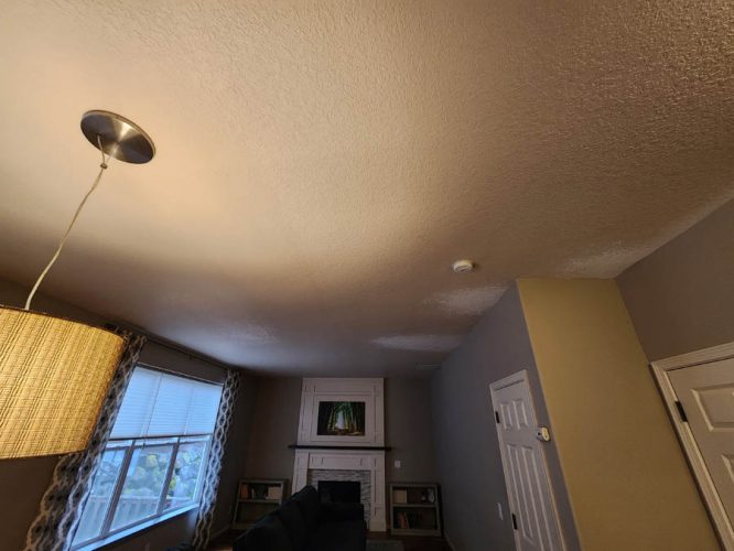 Ceiling repair and paint in Tigard - before photo showing white spots recently patched