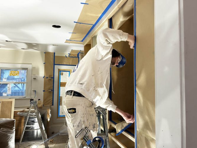 Pearl Painters team member working on kitchen cabinets