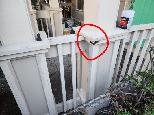 Wood porch railing in Portland with rotted section marked; painting supplies from Pearl Painters are on the porch.