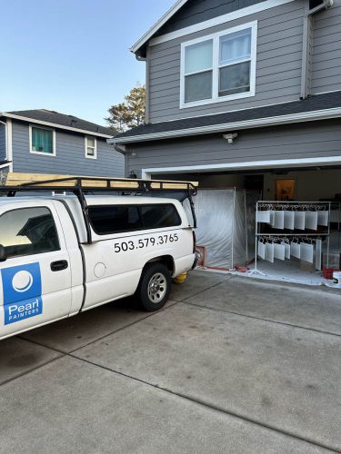 Pearl Painters truck in driveway with cabinets sprayed in garage