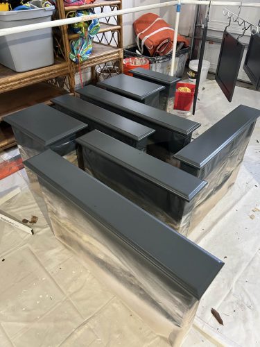Freshly painting kitchen cabinet doors drying in garage