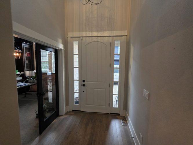 Gilbo white front door with side glass panels, wooden floors, office left. Painted by Pearl Painters in Portland.