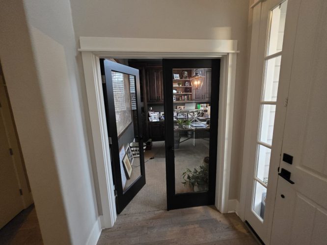 Hallway to Gilbo home office in Portland, with shelves, desk, computer, painter's plant. Pearl Painters' work not visible.