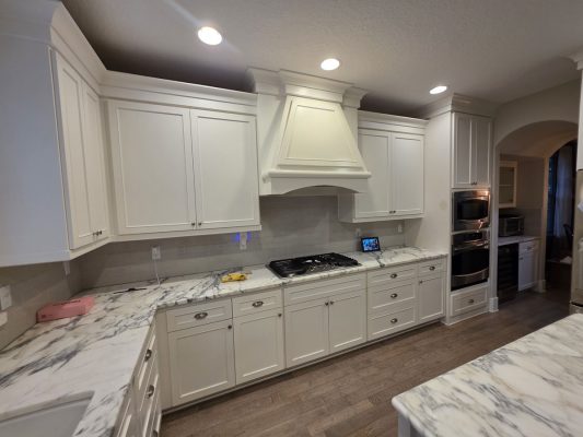 Modern Gilbo kitchen in Portland; white cabinets, marble counters, stainless appliances. Painted by Pearl Painters.