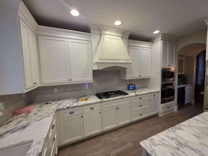 Modern Gilbo kitchen in Portland; white cabinets, marble counters, stainless appliances. Painted by Pearl Painters.