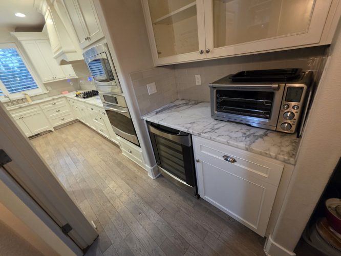Modern Gilbo kitchen in Portland with white cabinets, stainless appliances, marble top—painted by Pearl Painters in 2026.