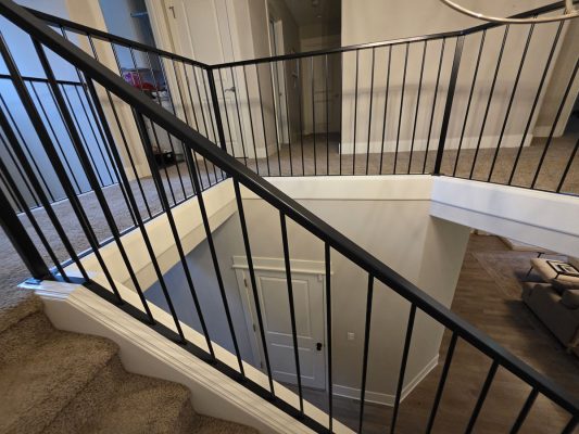 Modern Gilbo staircase, black railings, beige carpet steps, white wall. Painted by Pearl Painters, Portland, March 2026.