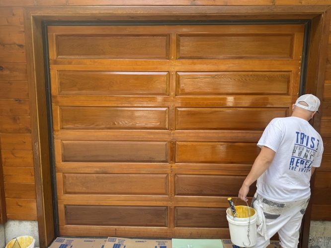 Pearl Painters painting a wood garage door in Portland.