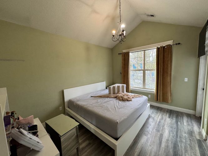 Bedroom with light green walls before being painted new modern color