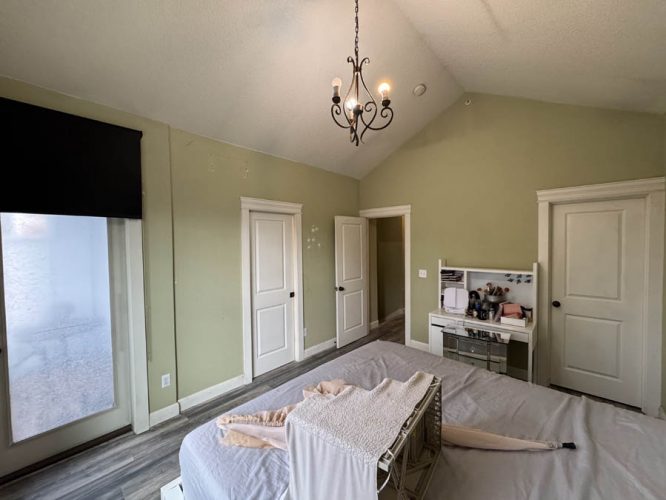 Bedroom with light green walls before being painted new modern color