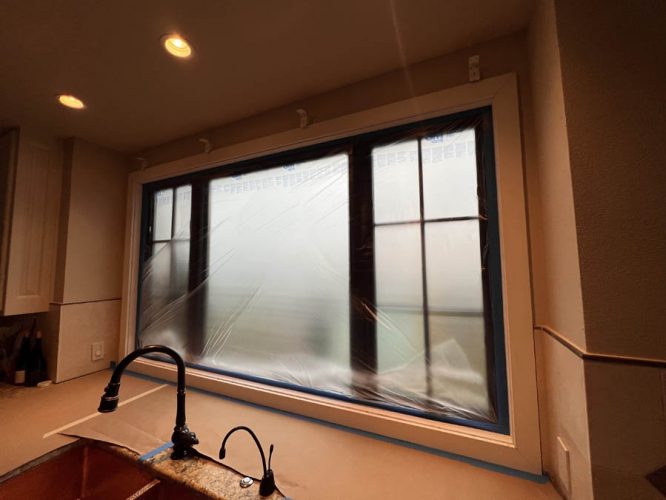 Kitchen window covered during painting prep