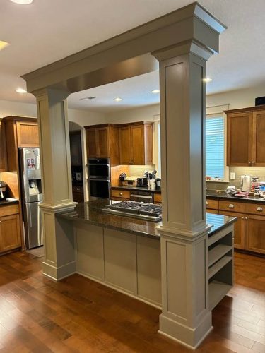 Rear of kitchen island with impressive columns to the ceiling, before being painted