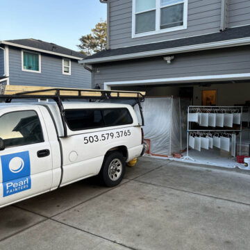 Pearl Painters truck in driveway with cabinets sprayed in garage