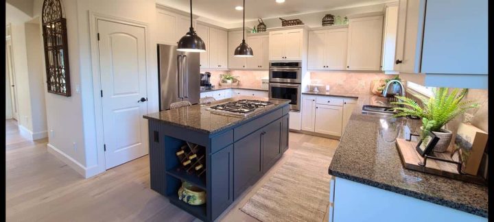 kitchen with white cabinets repainted, and blue island - all professionally painted