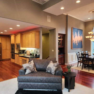 Open-concept living space with kitchen, dining area, and living room, enhanced by an interior painting project in Tigard that brightened the space.