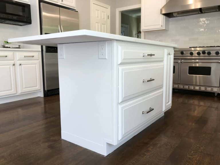 A Portland kitchen with an island featuring white cabinets.