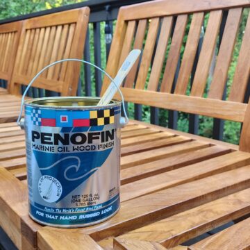 A can of paint sits on a wooden deck, ready for some summer BBQ prep.