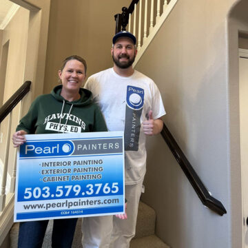 Happy client holds Pearl Painters sign