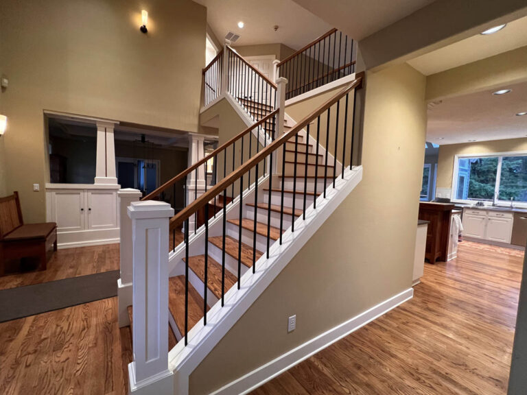 A staircase inside a Wilsonville home with high ceilings.