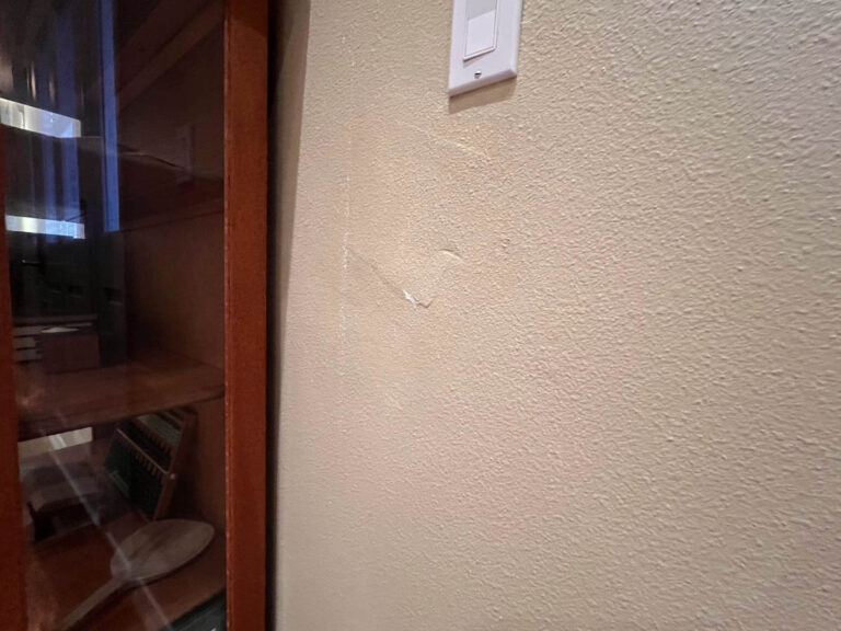 A wall with a piece of paper hanging on it in a Wilsonville home.