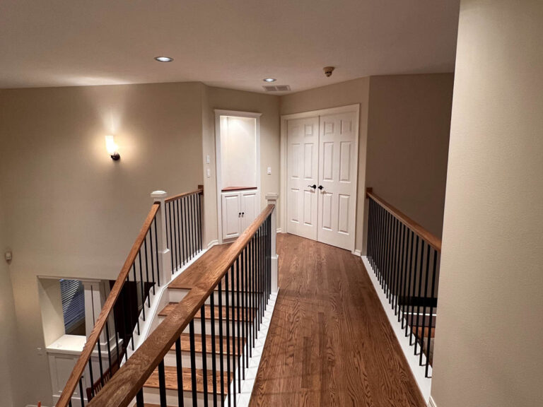 A stairway leading to a room in a Wilsonville home with high ceilings.