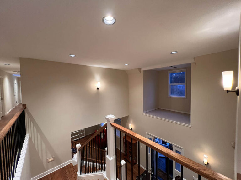 In the Wilsonville Home, there is a staircase with lights on the wall.